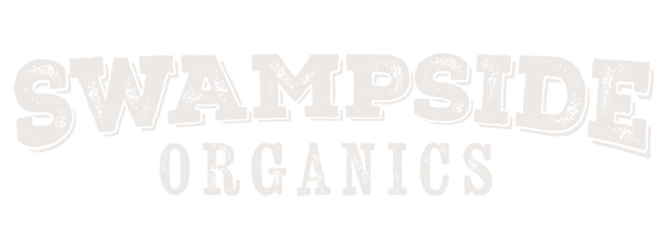 Stacked white text logo of Swampside Organics with a vintage texture 